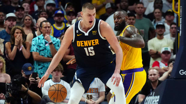 Nuggets’ Nikola Jokić posts up Lakers’ LeBron James.